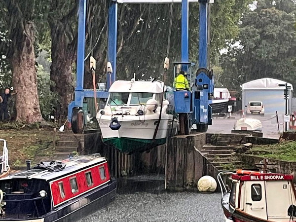 Boat being lifted into boatyard by crane